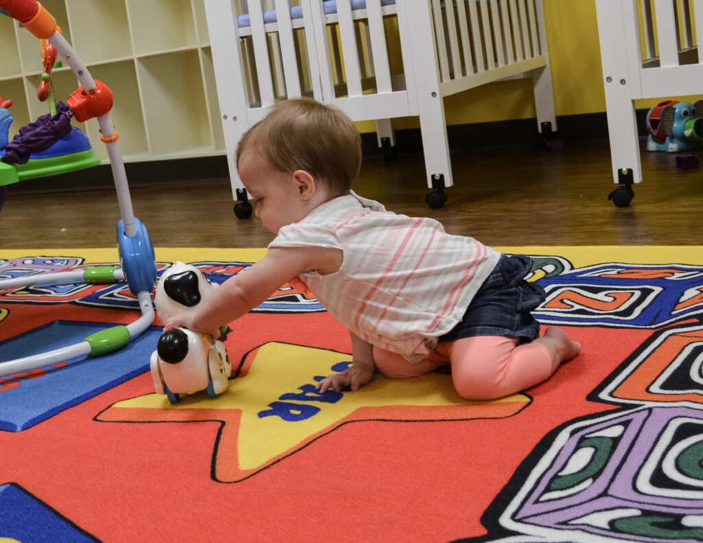 infant playing at tpu