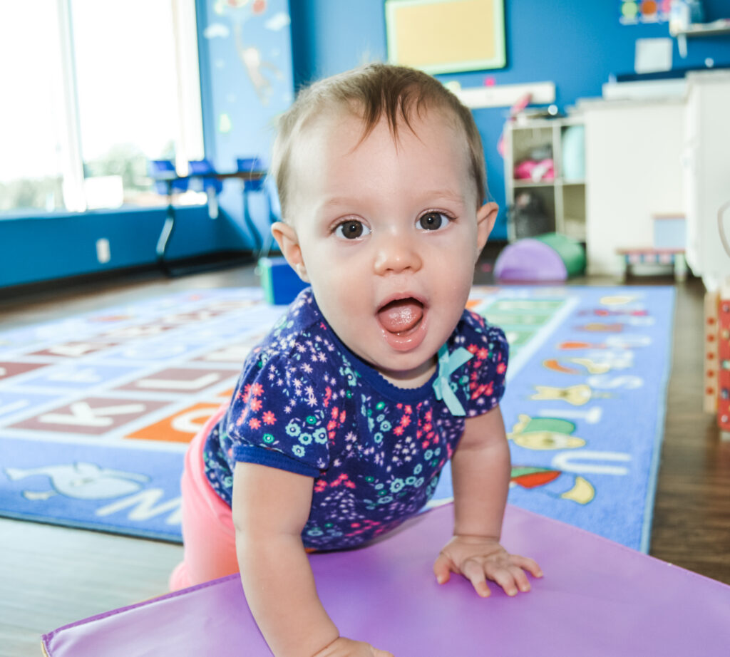 infant playing at TPU