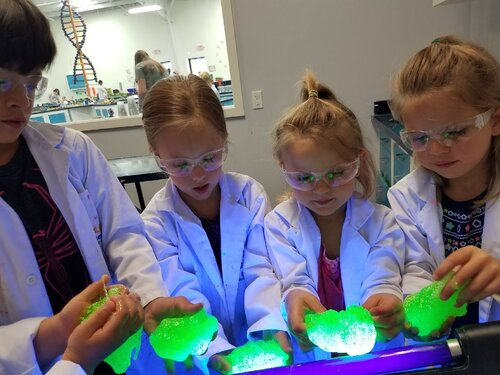 Children at Tiny People University Childcare Center in Magnolia, TX complete a science experiment.