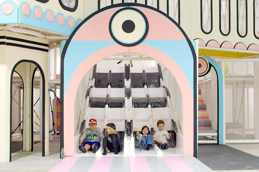 kids playing on an indoor slide