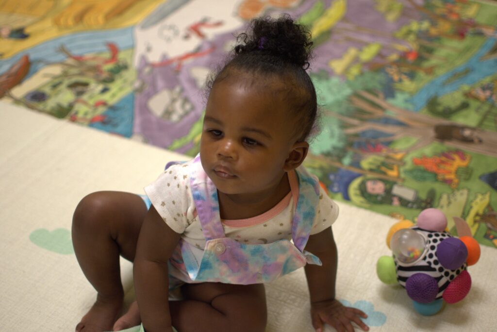 Infant playing at childcare in Magnolia