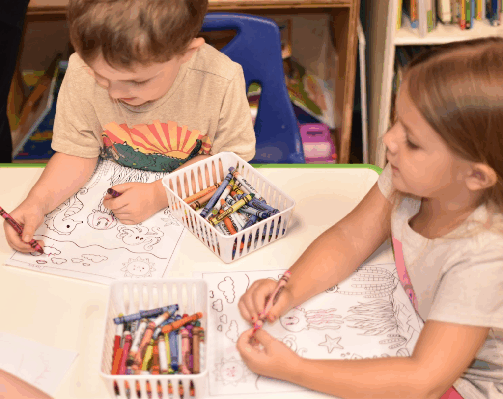 Children coloring at a table at Tiny People University Childcare Center in Magnolia, TX