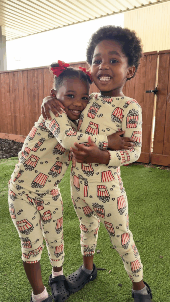 Children at Tiny People University smile while playing outside. 